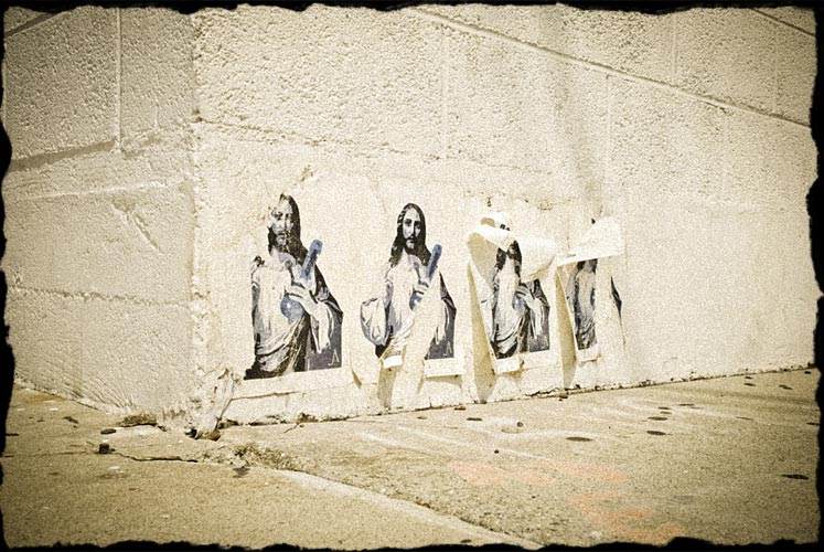 Paper pasted to the side of a business wall with image of Jesus