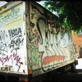 Moving truck completely covered in graffiti.
