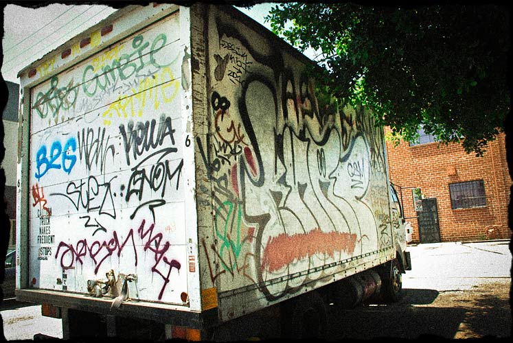 Moving truck completely covered in graffiti.