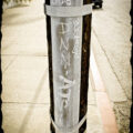 Random letters and words on electrical conduit of a telephone pole