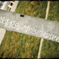 Nonsensical words graffitied on telephone pole casing.