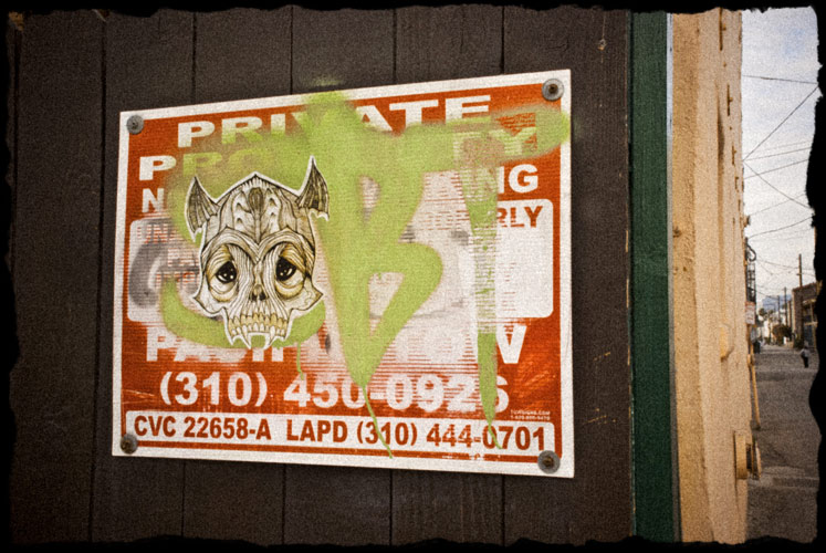 Private Property sign with sticker of skull plastered on it