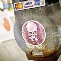 Sticker on parking meter with psychic sign in background